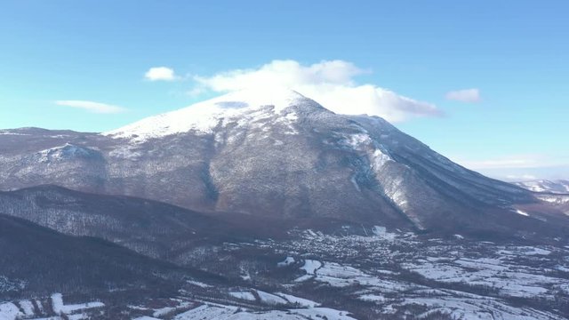 Rtanj mountain peak in the clouds by winter 4K drone video