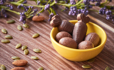 Ester chocolate with nuts on a wooden table