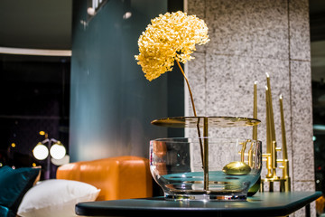 Beautiful flowers in unusual glass vase in an interior of apartments. A decor for the house and...