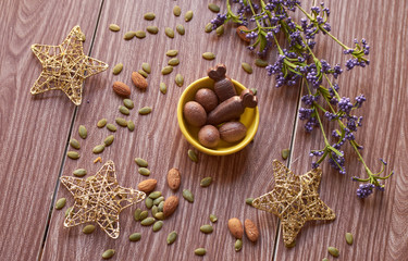 Ester chocolate with nuts on a wooden table
