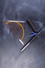 Fountain pen with ink cartridges and geo-triangle on a board