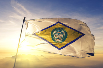 Dover city capital of Delaware flag waving on the top sunrise mist fog