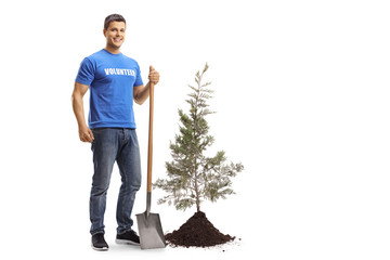Young male volunteer with a shovel standing next to a tree and soil © Ljupco Smokovski