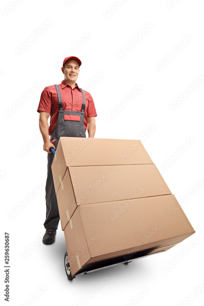 Poster Male worker with a stack of boxes on a hand truck smiling at the camera