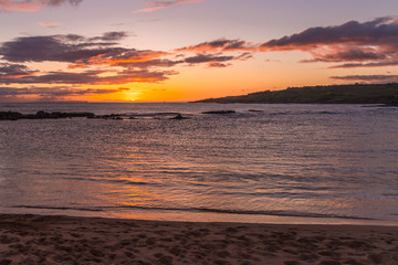 Fototapeta na wymiar Orange sunset over the ocean with reflections