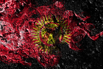 Kyrgyzstan smoky mystical flag on the old dirty wall background