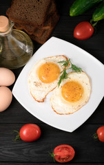 fried eggs on a white plate
