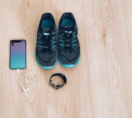 Cool runner sneakers with smartphone, earphones and fitbit sport watch. Ready for training, healthy life