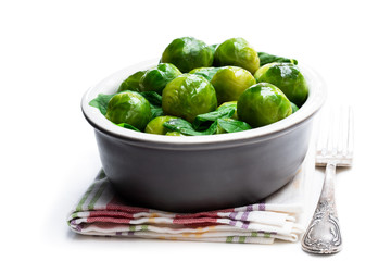 Cooked brussels sprouts with spinach isolated on white