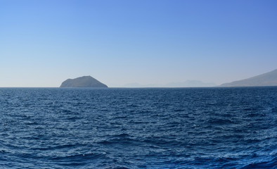 Panorama of the Aegean Sea overlooking the next islands and mountains in the summer evening after a decline. it is sewed from four vertical pictures