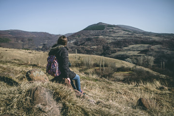 Fototapeta premium Young woman backpacker enjoy the view at mountain peak and peaceful environment