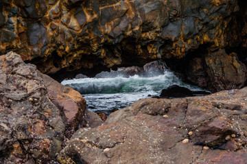 California sea cave with waves breaking inside