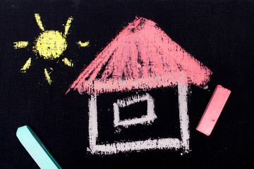 Colorful chalk drawing on a chalkboard: small house with pink roof