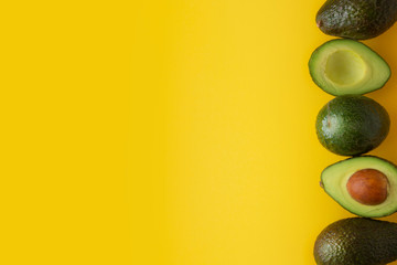 Ripe fresh avocado isolated on yellow background. Colorful healthy food background. Avocado isolated. Copy space.