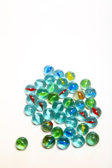 Group of glass marbles isolated on a white background with copy space