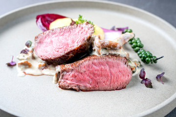 Barbecue wagyu sirloin steak from beef sliced with chanterelle and mashed potatoes as closeup on a...