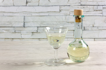 Cruet of White Wine and Stem Glass on a Wooden Table