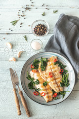 Grilled sea bream fish fillet with spinach