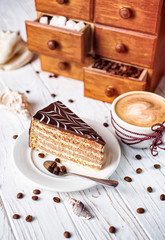 Chocolate cake with a cup of hot cappuccino