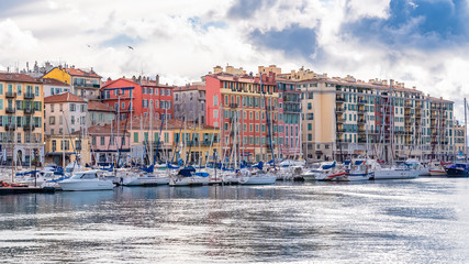 Nice in France, the harbor, old colorful buildings on the quays and boats in the marina 