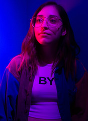 hip young woman staring neon lights