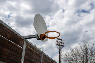 Basketball hoop with a cloudy sky