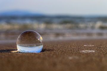 Fototapeta na wymiar Nature in Lens Ball - Orbuculum, Crystal ball view on the lake beach.