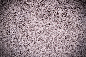 Fototapeta premium light-pink painted relief wall with vignette. background, texture.