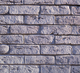 wall of white weathered bricks with shadows. background, texture.
