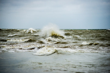 storm weather on the beach by rocky sea shore