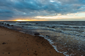 storm weather on the beach by rocky sea shore