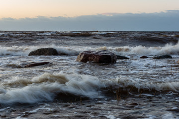 storm weather on the beach by rocky sea shore