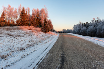 Obraz na płótnie Canvas snowy winter road covered in ice and snow