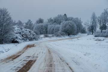 Fototapeta premium snowy winter road covered in ice and snow