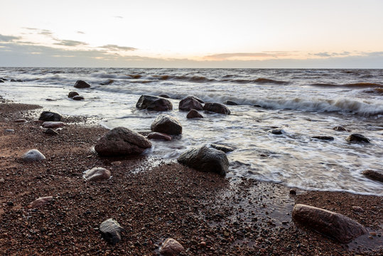 storm weather on the beach by rocky sea shore