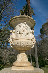 Obraz premium Roman Stone vase in the old classical style with trees in the Campo del Moro park, Madrid 