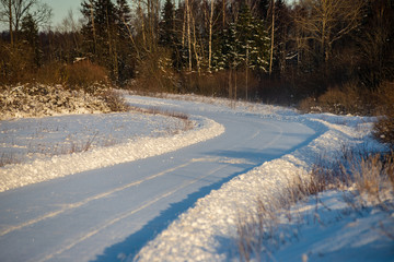 snowy winter road covered in ice and snow