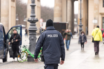 a german police officer at the brandenburger tor gate