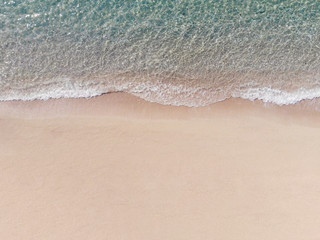 Fototapeta na wymiar Aerial View of Sandy Beach and Blue Sea with Wave