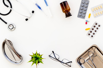 work desk of doctor in hospital with medical set on frame white background top view mockup