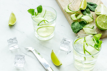 summer cocktails for freshness with lime, cucumber and ice on white background