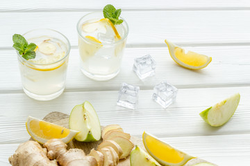 fresh drink with apple, orange and ice on white background