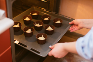 Fototapeta na wymiar Bake muffins on the baking sheet in the oven