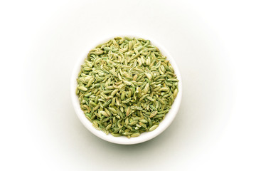 Saunf, Fennel seeds in the white ceramic bowl, isolated on white, top view