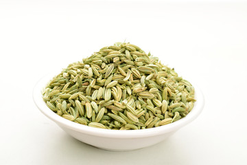 fennel seeds in white ceremic bowl isolated on white background