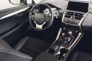 Obraz na płótnie Canvas car interior. Modern car speedometer and illuminated dashboard. Luxurious car instrument cluster. Close up shot of car instrument panel.