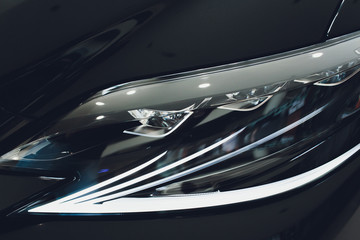Obraz na płótnie Canvas Modern Car Closeup Photo. Headlight and Alloy Wheel Closeup. Modern Transportation.