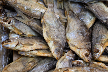 Dried fish on a market counter close up. Seafood
