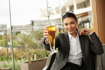 businesswoman drinking beer at cafe