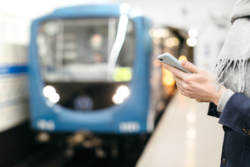 Man holds smartphone in the hands, chatting and sending messages, surfing in the internet while...